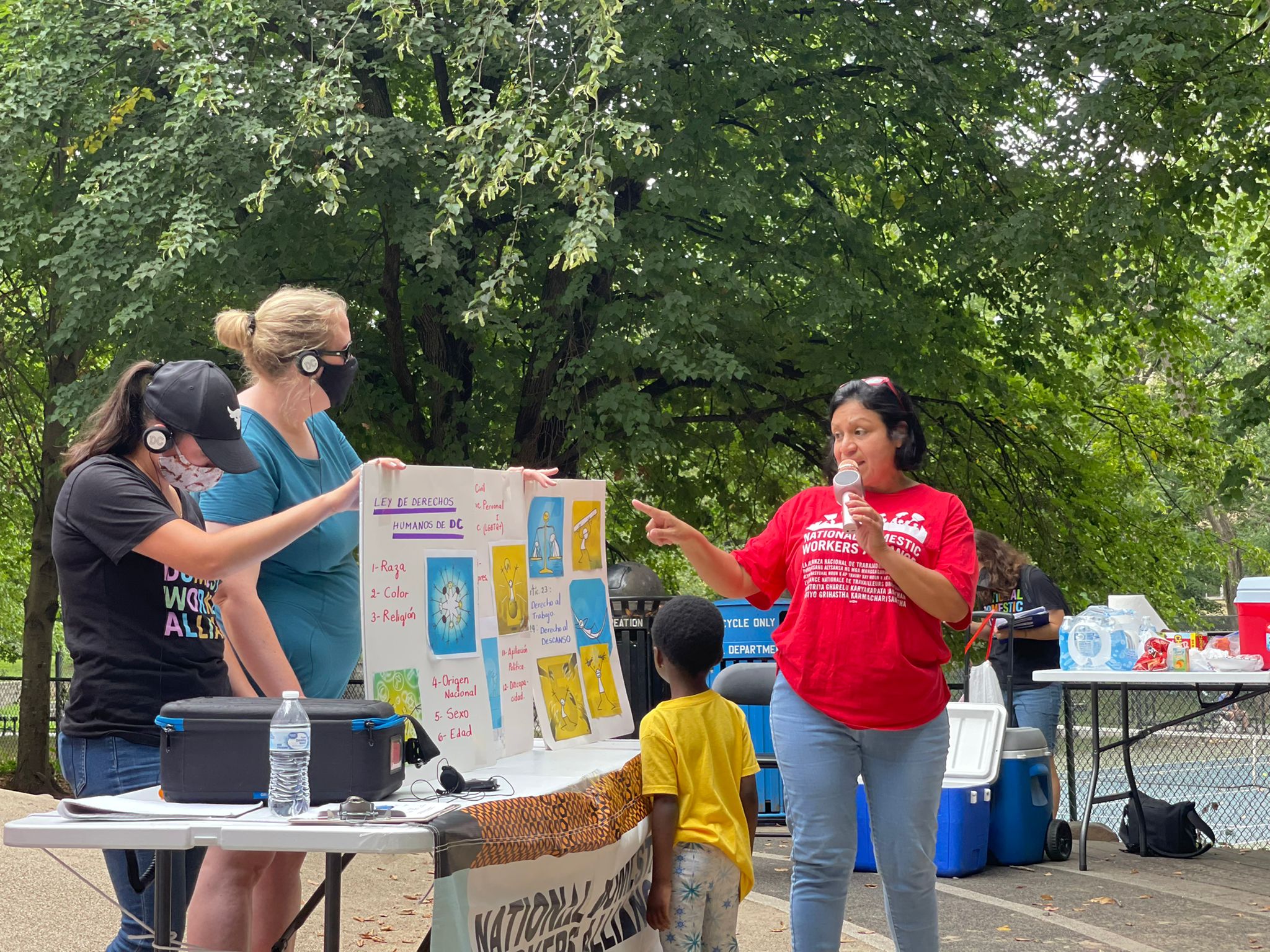 Two participants in the chapter's leadership development program present about the DC Domestic Workers Bill of Rights at a monthly membership meeting